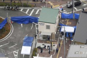 Japan arrests man for stabbing police officer, taking gun