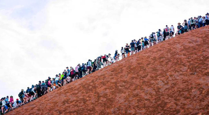 Uluru climb ban: Tourists climb sacred rock on last day