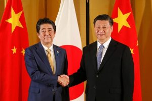 As world gets tough on China, Japan treads cautiously