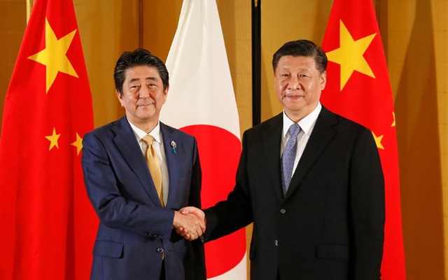 As world gets tough on China, Japan treads cautiously