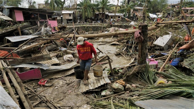 Typhoon leaves 12 dead, traps people on roofs in Philippines