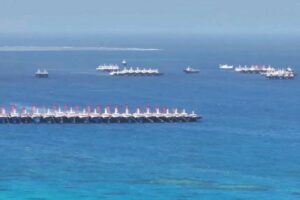 Philippines says over 135 Chinese boats ‘swarming’ reef off its coast